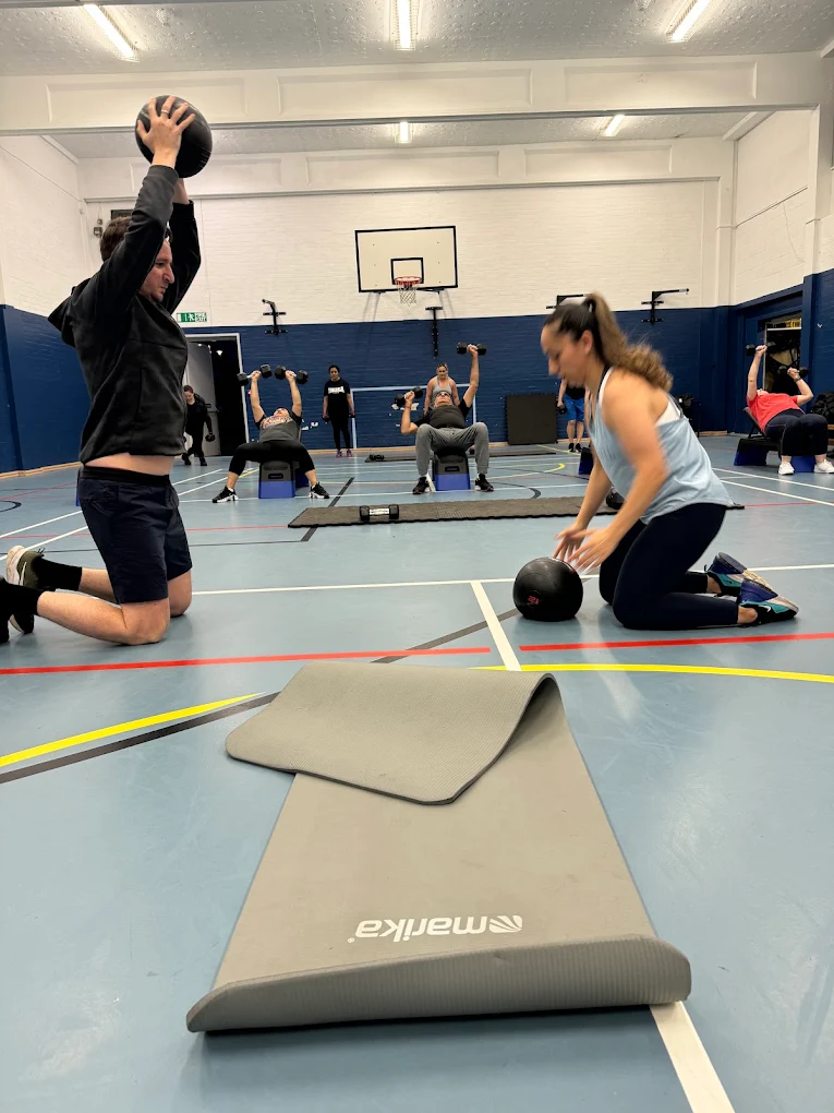 Members training with medicine balls