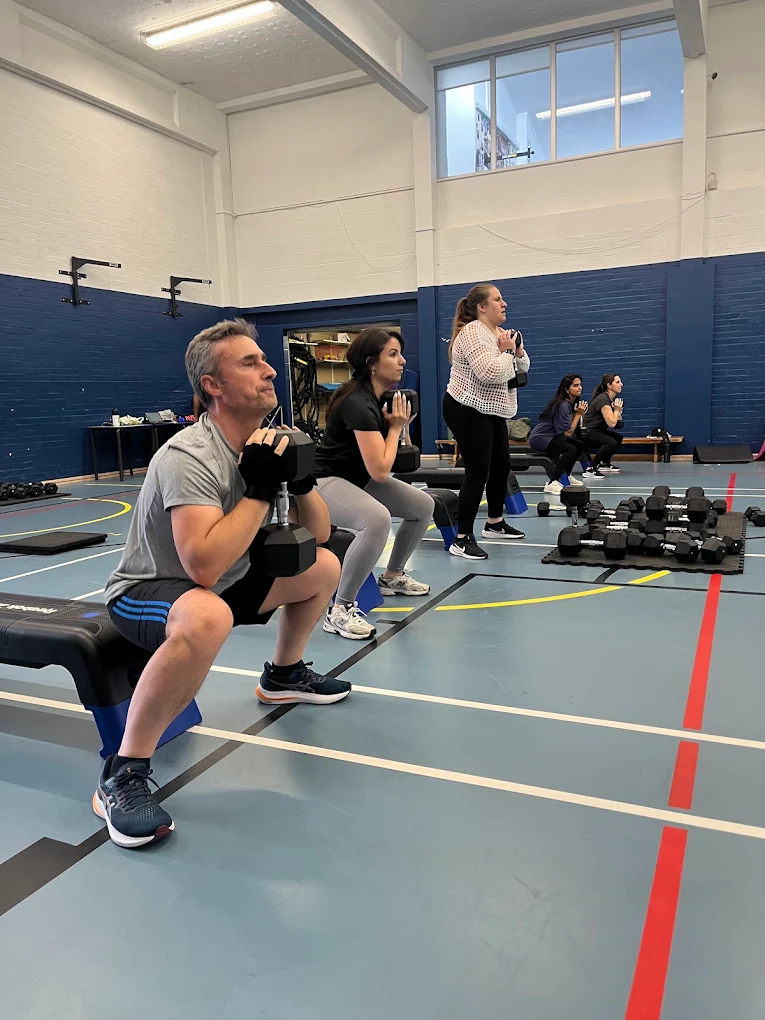 Members performing weighted squats